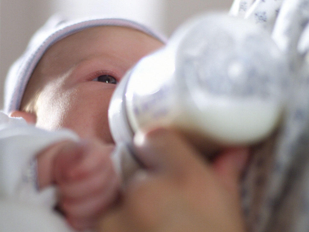 baby drinking milk in bottle